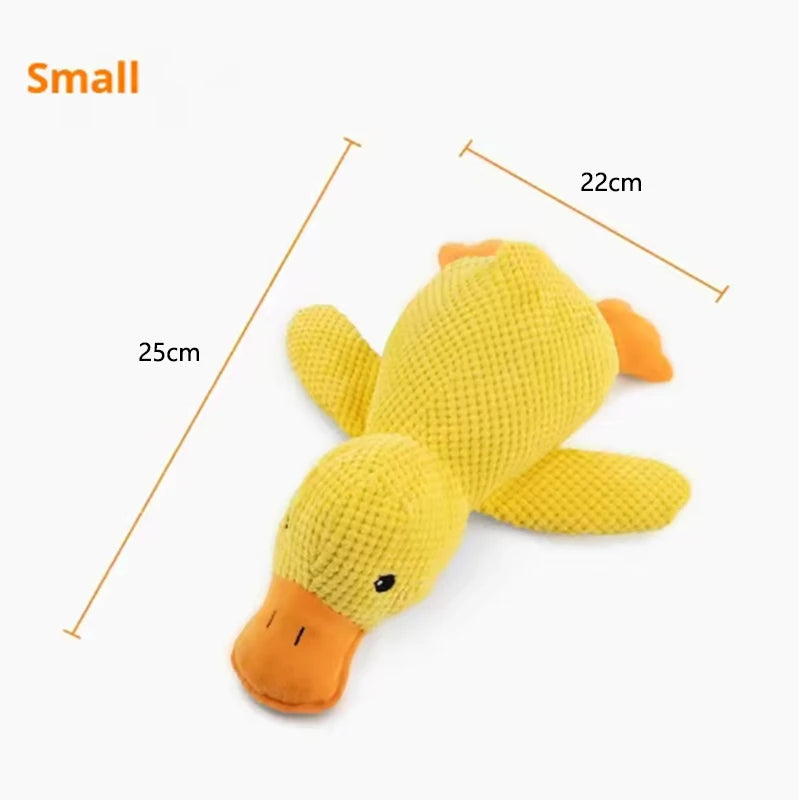 Dog sleeping with a dog hug duck toys to relieve