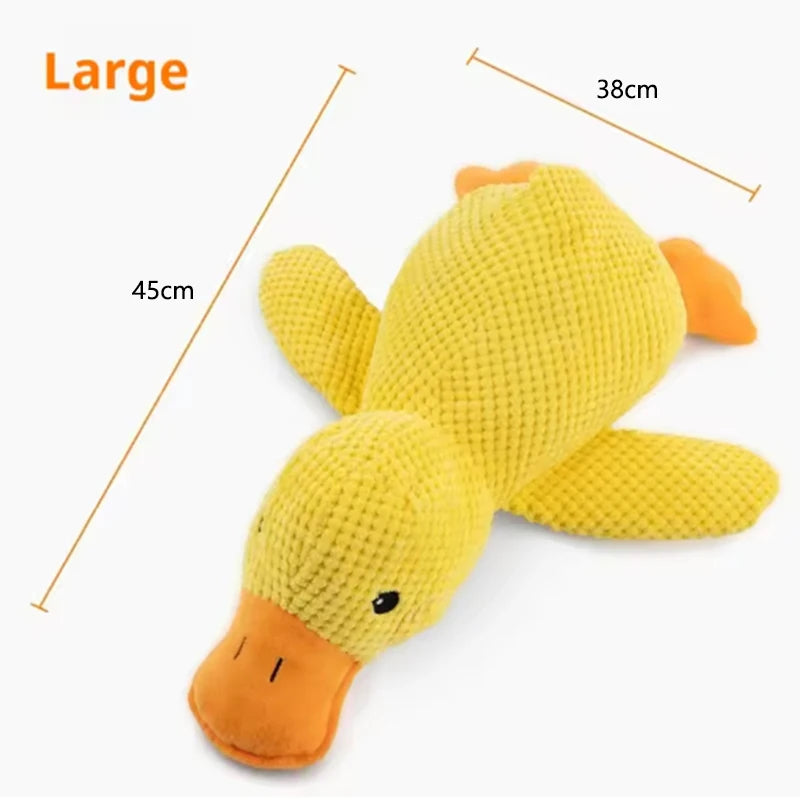 Dog sleeping with a dog hug duck toys to relieve